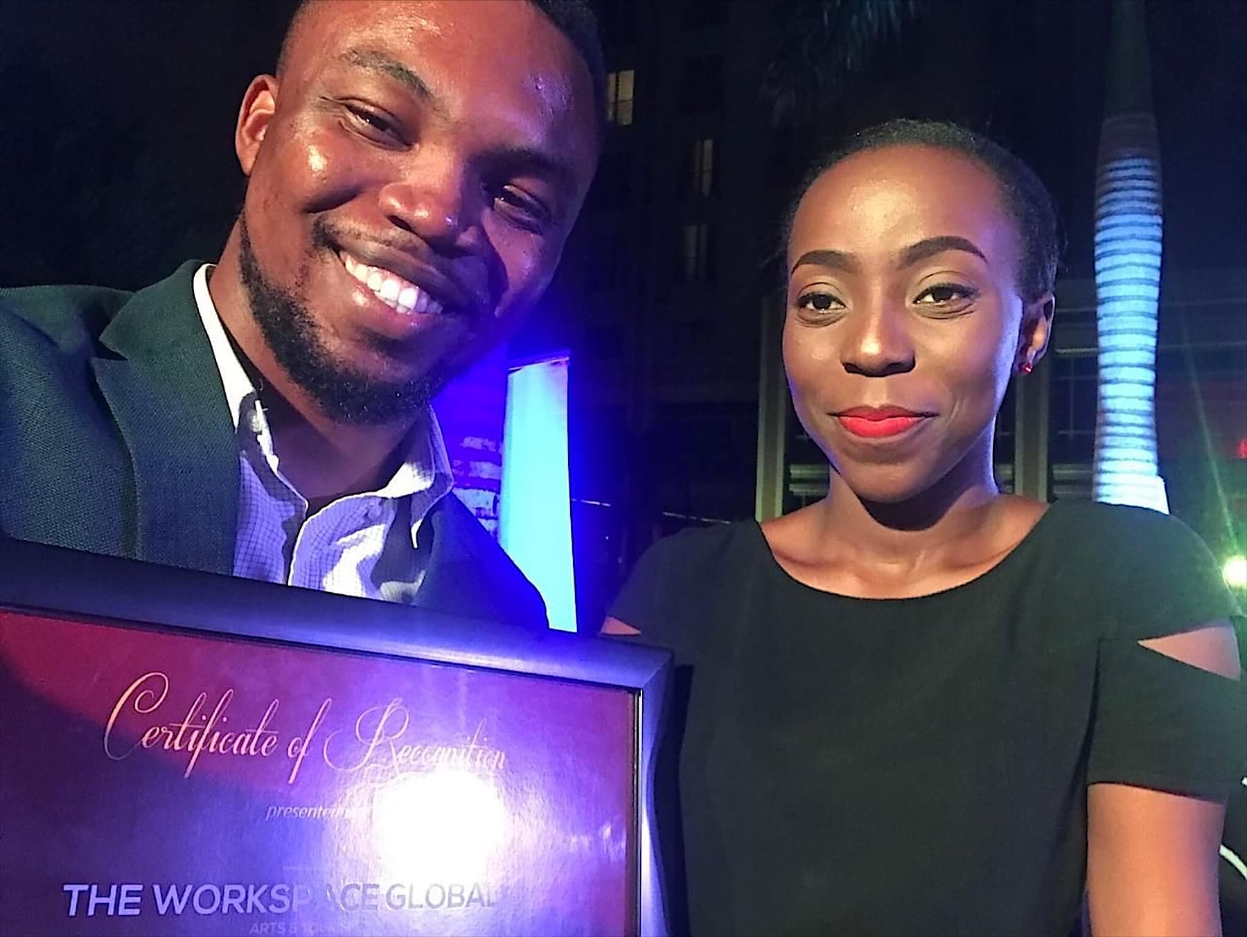 Sydney Scott Sam holding a Certificate of Recognition for The Workspace Global