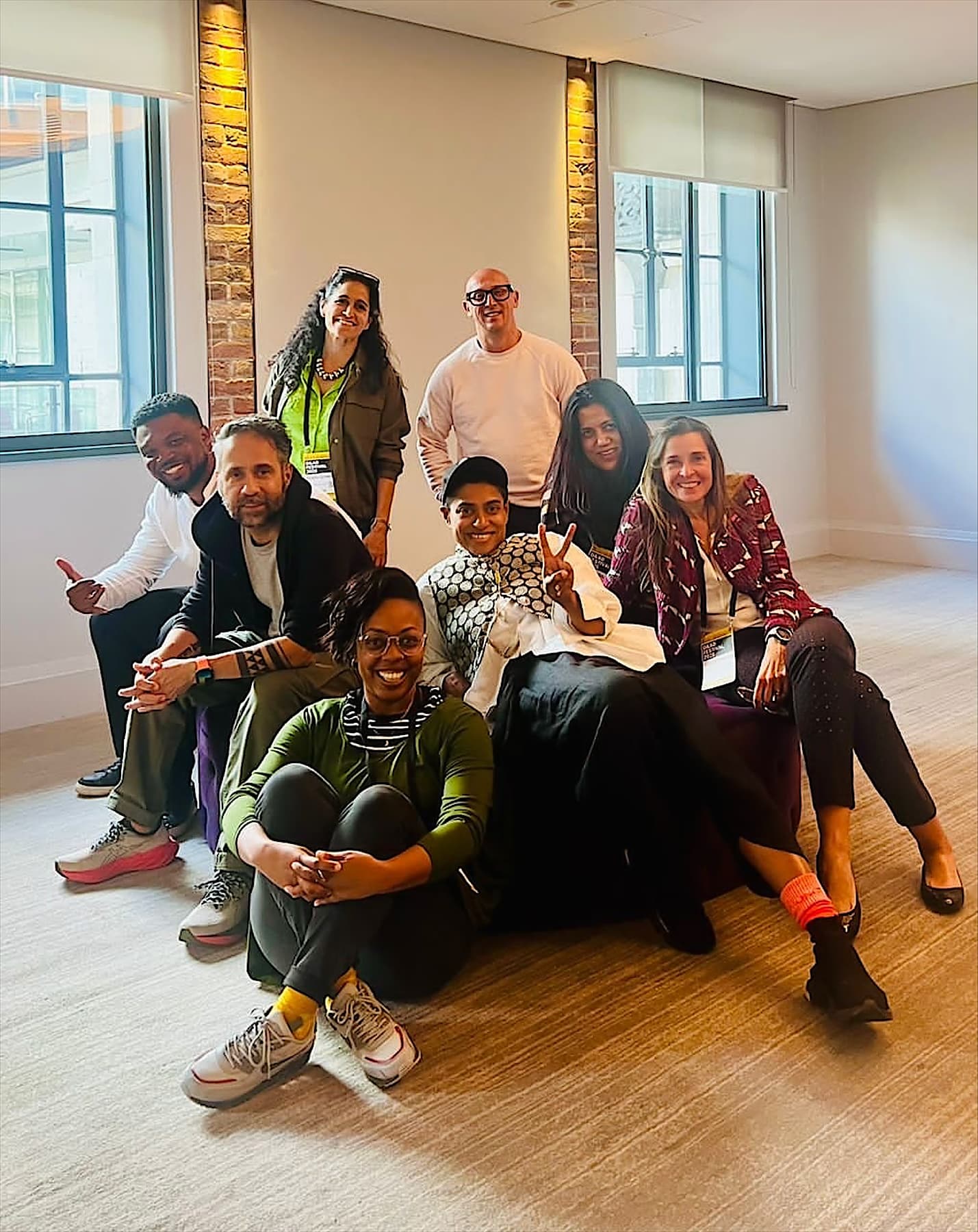 Partners gathered in a bright, brick-walled room