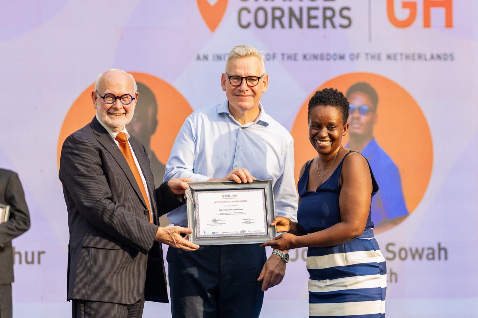 A certificate presented on stage at Orange Corners Ghana, an initiative of the Kingdom of the Netherlands