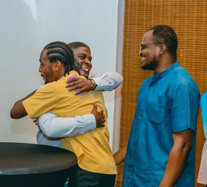 Guests hugging and laughing at a Workspace community night